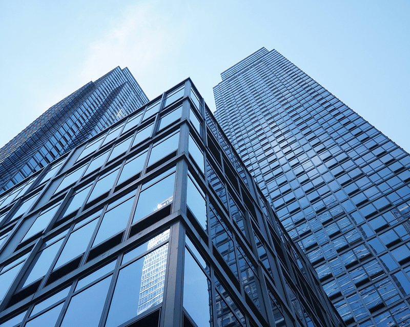 Skyscrapers viewed from below against blue sky.
