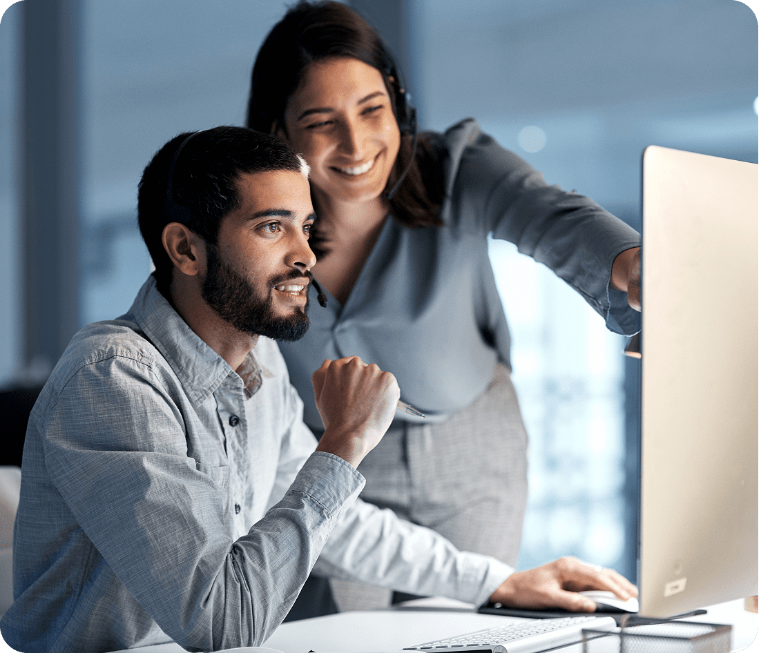 Two colleagues collaborating at a computer.