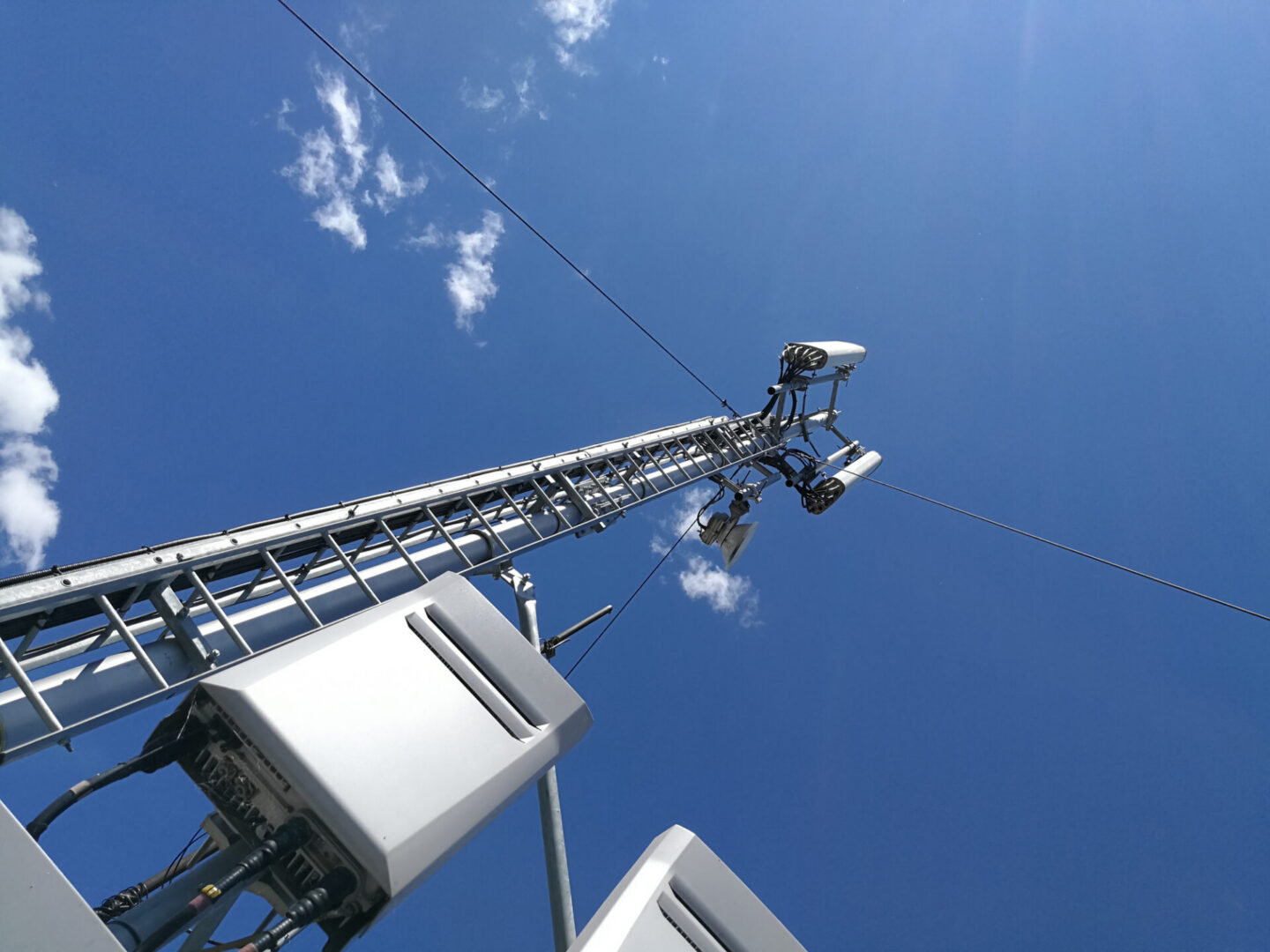 Telecommunications tower with antennas against blue sky
